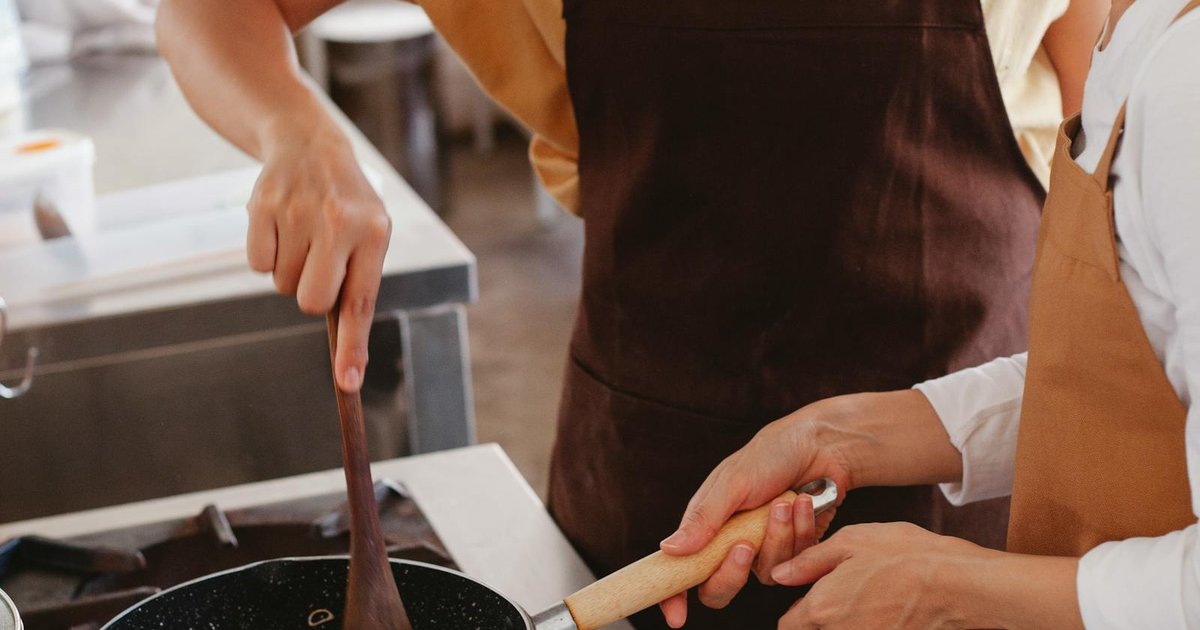 A Greek cooking class with fresh Mediterranean ingredients spread across a wooden table